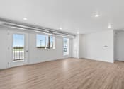 Thumbnail 29 of 44 - an empty living room with white walls and wood floors