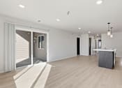 Thumbnail 51 of 68 - A large, empty room with a sliding glass door leading to a balcony.