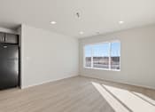 Thumbnail 50 of 68 - A spacious room with a large window overlooking a construction site.