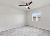 Thumbnail 49 of 68 - A room with a ceiling fan and a window.