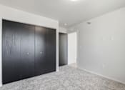 Thumbnail 54 of 68 - A room with a white wall and a grey carpet.