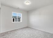 Thumbnail 61 of 68 - A room with a window and carpeted floor.