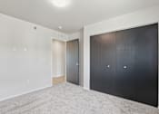 Thumbnail 57 of 68 - A room with a carpeted floor and two sets of doors.