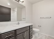 Thumbnail 63 of 68 - A bathroom with a white sink and a toilet.