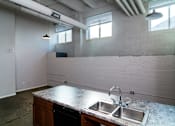 Thumbnail 13 of 17 - A kitchen with a granite countertop and a double sink.