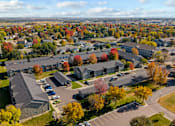 Thumbnail 5 of 41 - A large building complex surrounded by trees with autumn leaves.