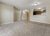 Thumbnail 32 of 41 - A spacious room with a carpeted floor and a mirror on the wall.