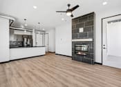 Thumbnail 46 of 73 - A modern kitchen with a wood floor and a fireplace.