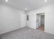 Thumbnail 26 of 32 - A room with a grey carpet and white walls.