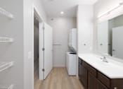 Thumbnail 20 of 32 - A white bathroom with a white sink and a white cabinet.