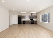 Thumbnail 27 of 32 - A spacious kitchen with wooden floors and modern appliances.