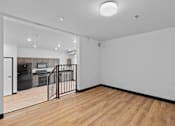 Thumbnail 30 of 73 - A room with wooden floors and white walls.