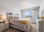 Thumbnail 7 of 20 - Bright, vacant bedroom with neutral walls and carpet flooring.