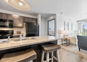 Thumbnail 5 of 20 - Spacious, combined kitchen and living room with breakfast bar seating.