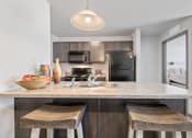 Thumbnail 3 of 20 - Spacious, combined kitchen and living room with breakfast bar seating.