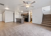 Thumbnail 2 of 20 - Modern open-concept kitchen and living area with black appliances.