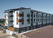 Thumbnail 20 of 41 - a large apartment building with a street in front of it
