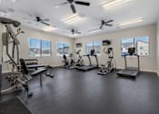 Thumbnail 30 of 40 - A spacious home gym with a variety of exercise equipment.