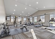 Thumbnail 11 of 47 - A spacious gym with a variety of equipment including treadmills, weights, and exercise machines.