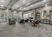 Thumbnail 36 of 46 - A modern living room with grey flooring and furniture.