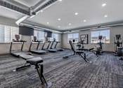 Thumbnail 9 of 58 - A gym with treadmills, exercise bikes, and other equipment.