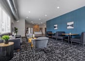 Thumbnail 46 of 58 - A modern waiting room with grey and blue accents.
