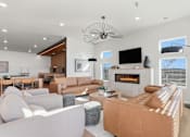 Thumbnail 41 of 68 - A modern living room with a fireplace and a television.