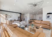 Thumbnail 39 of 68 - A modern living room with a large sectional sofa and a coffee table.