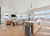 Thumbnail 10 of 68 - A modern kitchen with a large island and a dining area.