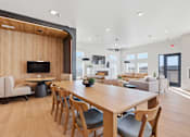 Thumbnail 4 of 68 - A modern dining room with a long wooden table and chairs.