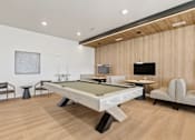 Thumbnail 59 of 68 - A room with a pool table and a TV.