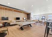 Thumbnail 66 of 68 - A room with a pool table and chairs.