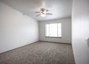 Thumbnail 10 of 37 - Bright, vacant bedroom with neutral walls and carpet flooring.