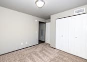 Thumbnail 63 of 81 - A room with a carpeted floor and a white door.