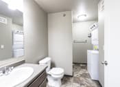 Thumbnail 68 of 81 - A bathroom with a toilet, sink, and a white cabinet.