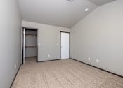 Thumbnail 57 of 81 - A room with a carpeted floor and a door leading to a closet.
