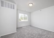 Thumbnail 14 of 16 - A room with a grey carpet and a window.