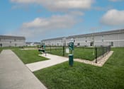 Thumbnail 19 of 53 - A grassy area with a fence and a sign that says "H" on it.