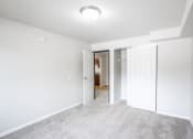 Thumbnail 11 of 15 - a bedroom with a closet and a door to a bathroom