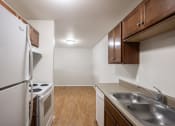 Thumbnail 12 of 15 - a kitchen with stainless steel appliances and wooden cabinets and a white stove and refrigerator