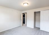 Thumbnail 3 of 15 - an empty bedroom with a closet and a door to a bathroom