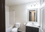 Thumbnail 6 of 15 - a bathroom with a sink toilet and a mirror
