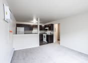 Thumbnail 13 of 15 - a renovated living room and kitchen with white carpet and black cabinets