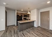 Thumbnail 8 of 45 - A kitchen with a wooden floor and a countertop.