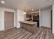 Thumbnail 43 of 45 - A kitchen with a wooden floor and a countertop.