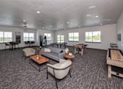 Thumbnail 10 of 45 - A spacious living room with grey carpeting and furniture.