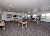 Thumbnail 5 of 45 - A room with a pool table, air hockey table, foosball table, and a shuffleboard table.