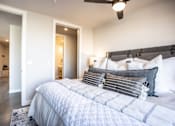 Thumbnail 4 of 41 - A bedroom with a large bed and a ceiling fan.