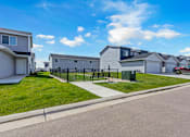 Thumbnail 48 of 58 - A row of houses with a clear blue sky above them.