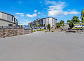 Thumbnail 44 of 81 - A parking lot with a building and a wall in the background.